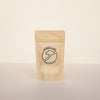 A standing pouch packaging of Umami Salt with a transparent window showing the product inside. The package is beige with a black label that includes the brand name and a mushroom illustration.